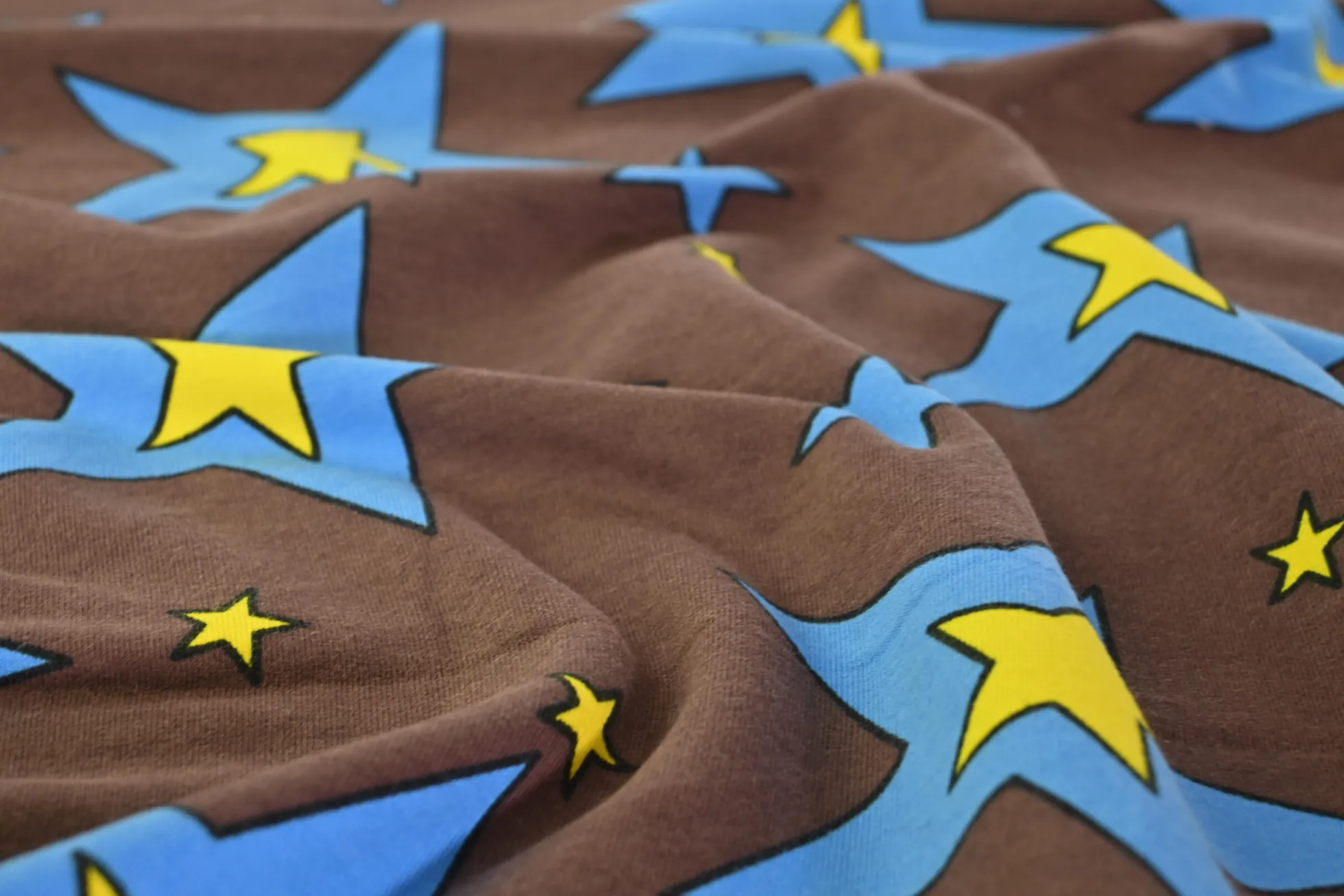 French terry – Cartoon stars on brown