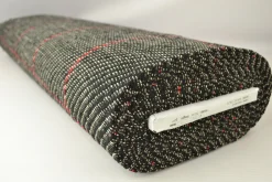 Wollen stof – Zwart melange met rode ruit bouclé